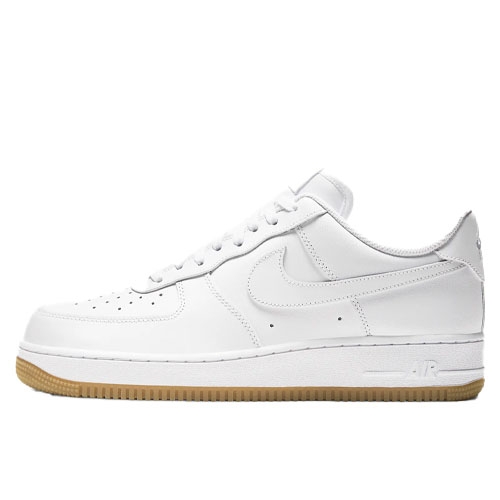 White Nike Air Force 1 '07 sneakers feature a low-top design with a white leather upper, perforated toe box, and a gum rubber outsole. The side showcases the iconic Nike swoosh.