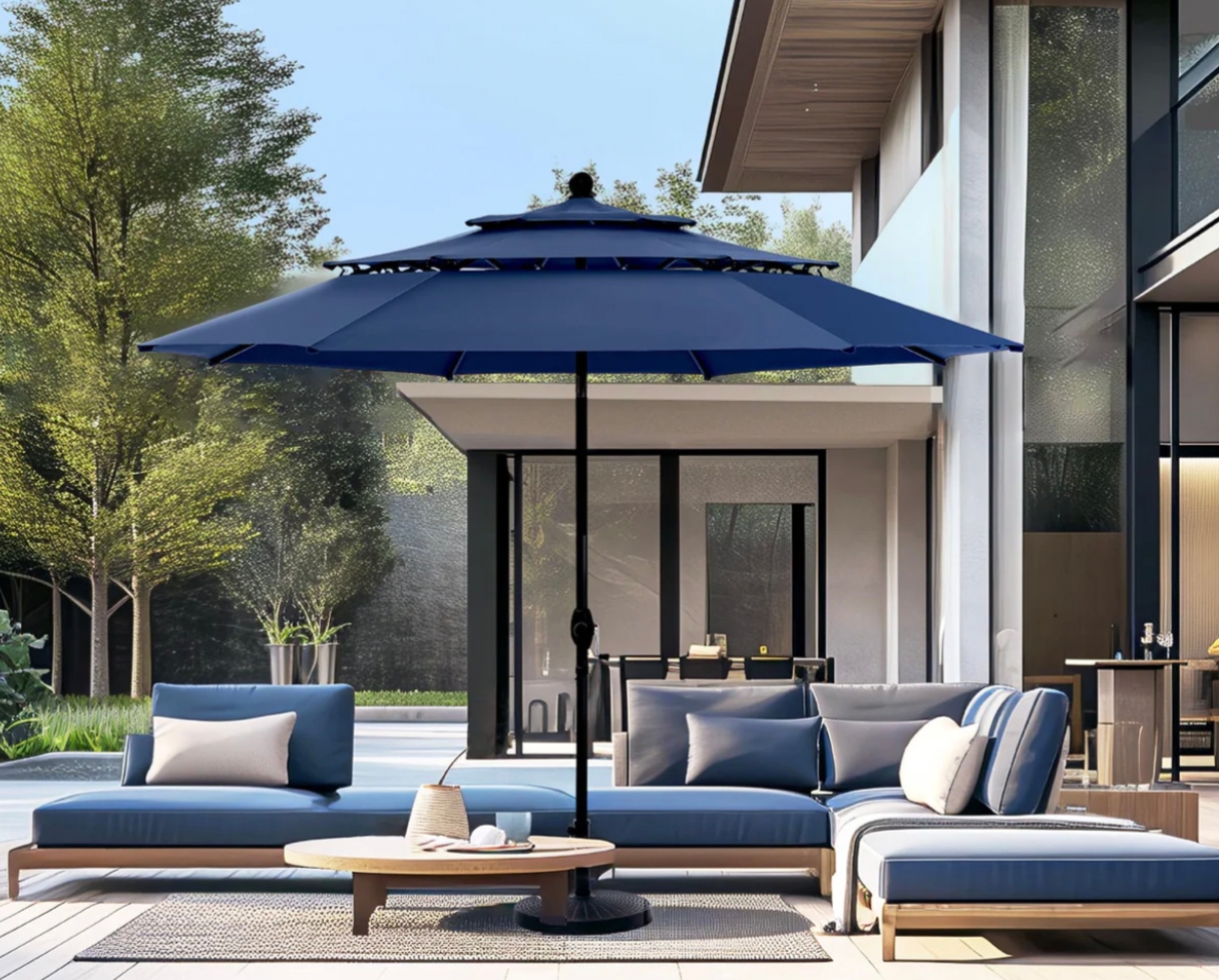 A large navy blue patio umbrella with tilt functionality, featuring a black central pole and sitting over an outdoor seating area.