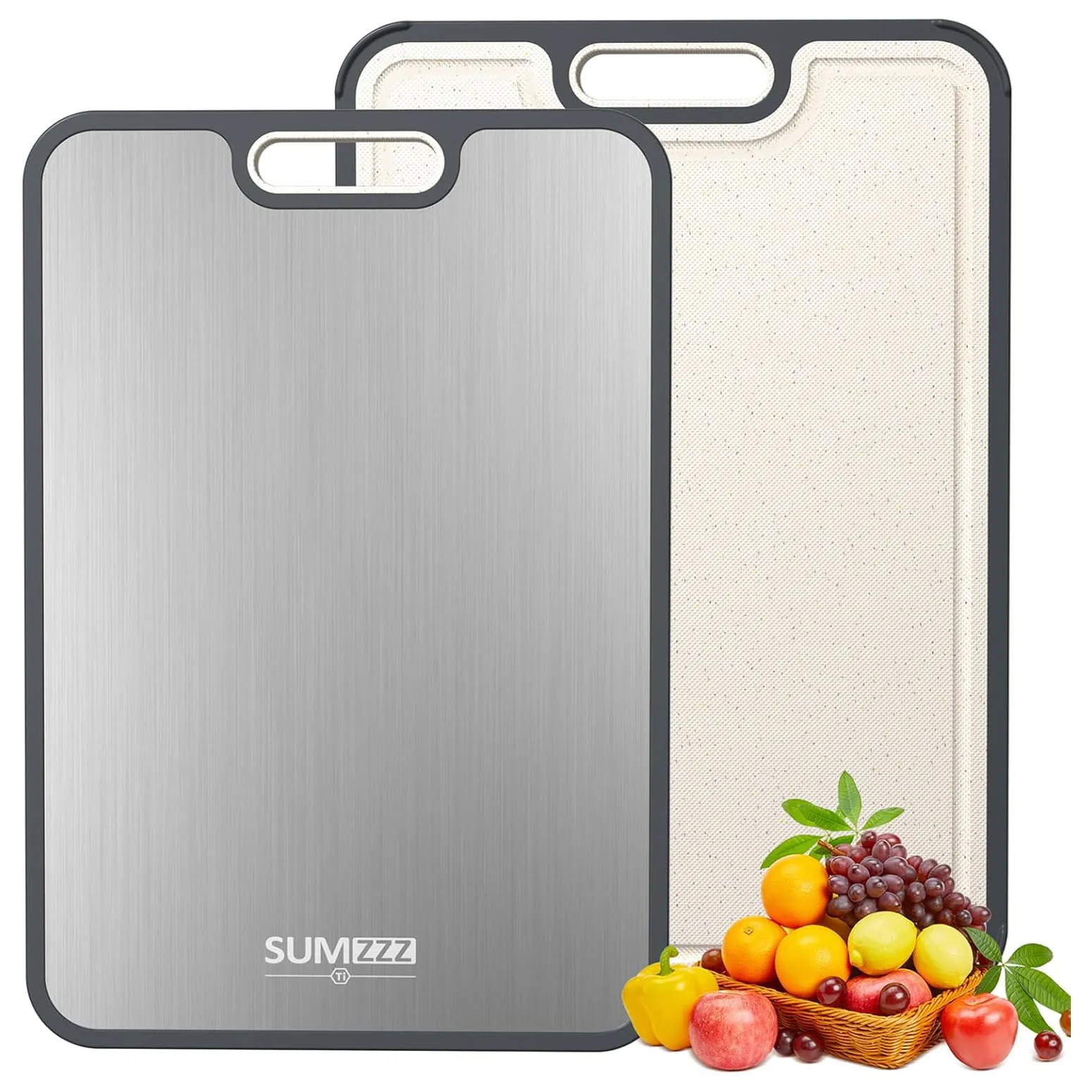 Dual-sided cutting board with a stainless steel side and a textured non-slip side, trimmed in gray, accompanied by a basket of fruits and vegetables.