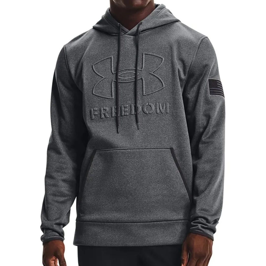 Dark grey Under Armour hoodie featuring a large logo with \“Freedom\“ text on the front and an American flag patch on the sleeve.