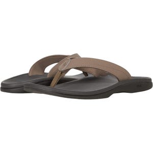 Brown flip-flop sandals with wide straps and black soles, featuring a small metallic logo detail on the strap.