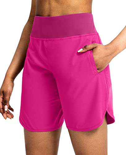 Vibrant pink athletic shorts for women, featuring a wide waistband and a side pocket.