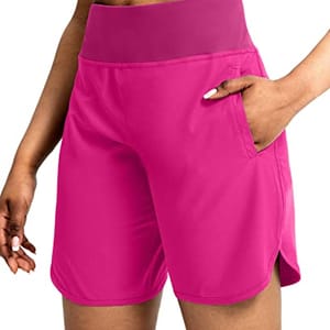 Vibrant pink athletic shorts for women, featuring a wide waistband and a side pocket.