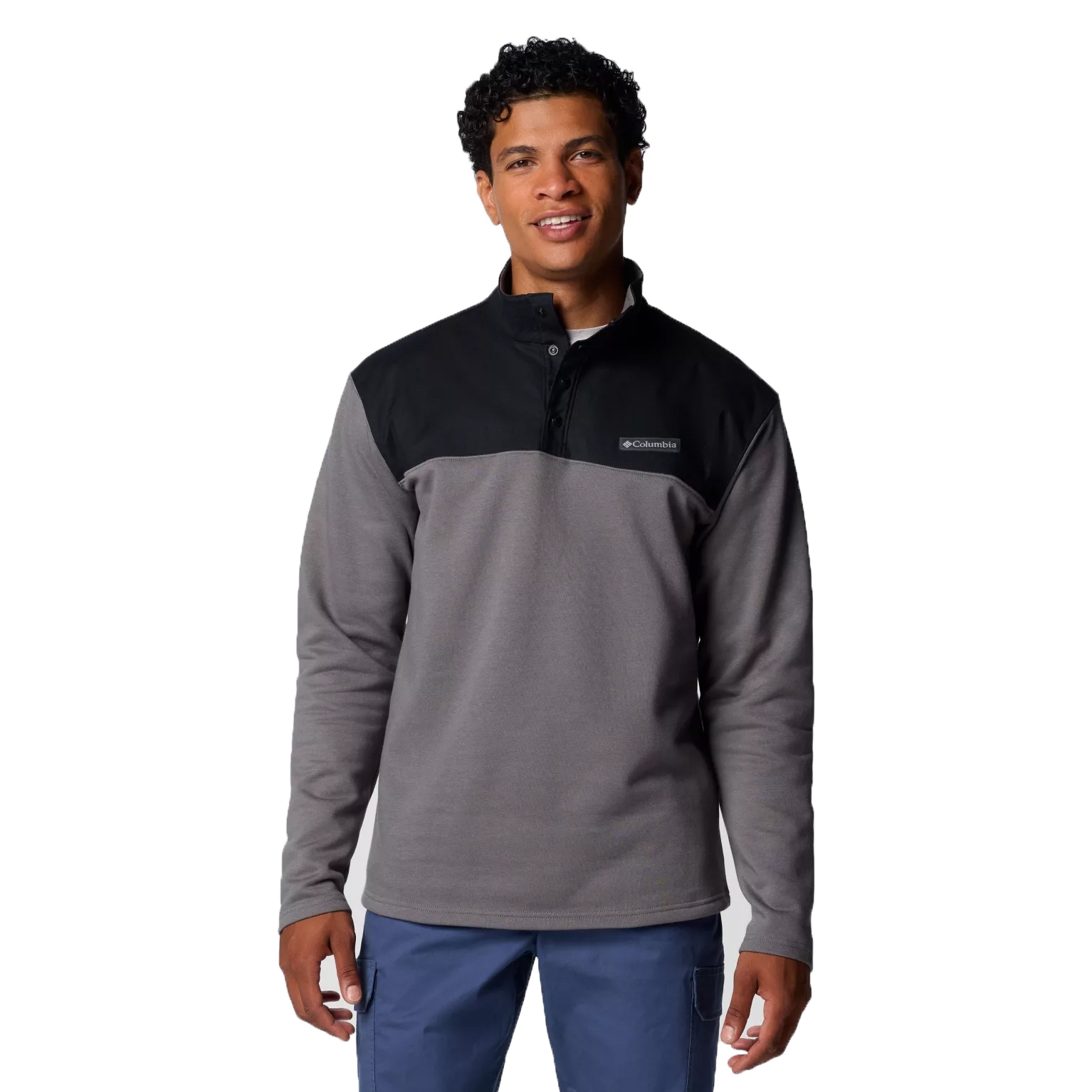 A Columbia Pitchstone Pullover featuring a two-tone design with a black upper and gray body, a button-up collar, and a visible Columbia logo on the chest.