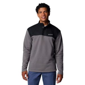A Columbia Pitchstone Pullover featuring a two-tone design with a black upper and gray body, a button-up collar, and a visible Columbia logo on the chest.