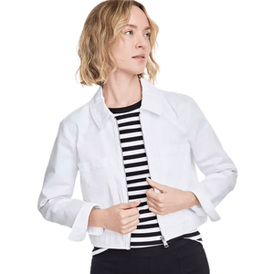 White cropped chore jacket with a zipper front and fold-over collar, worn over a black and white striped top. The jacket has a casual, fitted style with long sleeves.