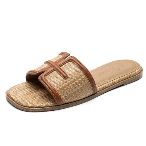 A woven sandal with a tan upper and leather trim, featuring a flat sole and slip-on design.