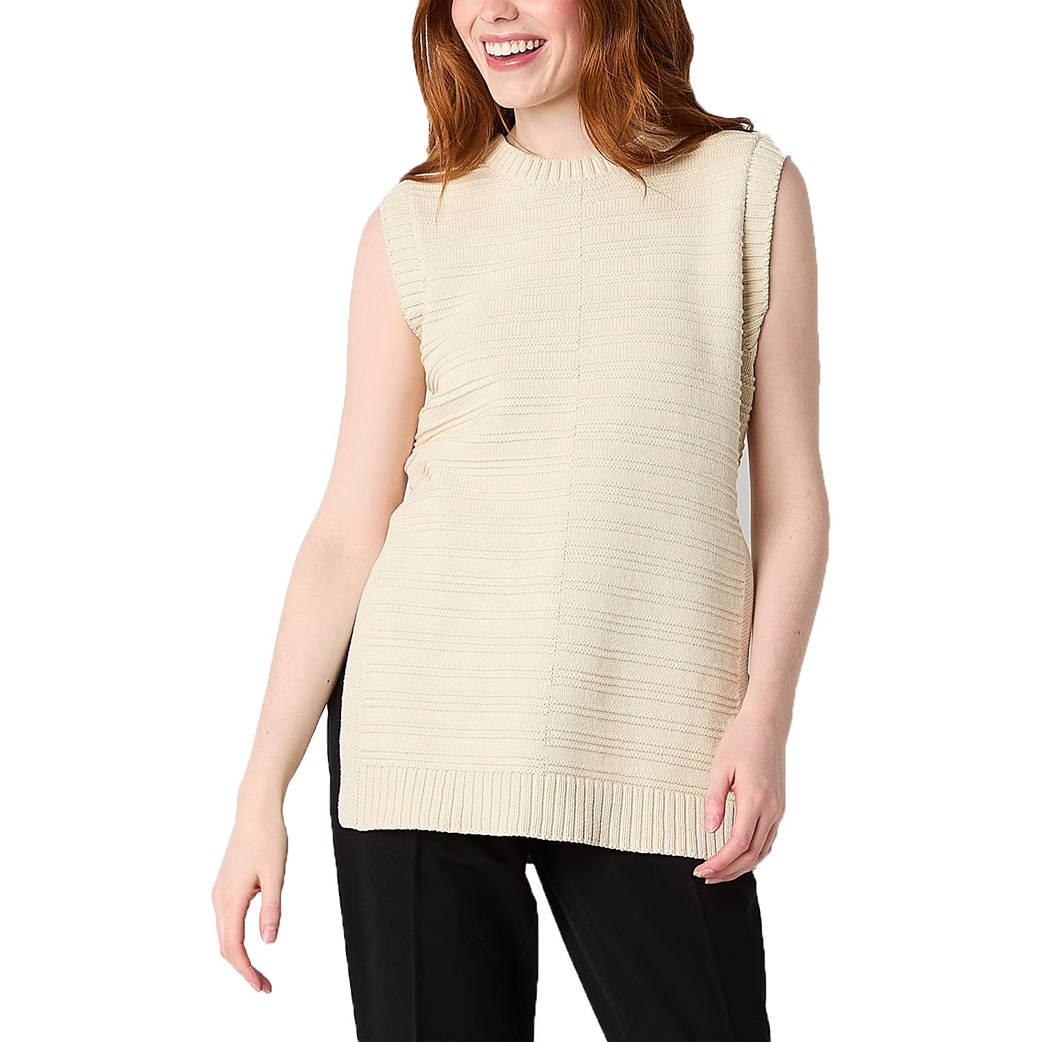 A sleeveless, crew neck sweater in a pale, solid color with a ribbed texture and a hem that falls at the hip. The person is wearing the sweater with black pants.