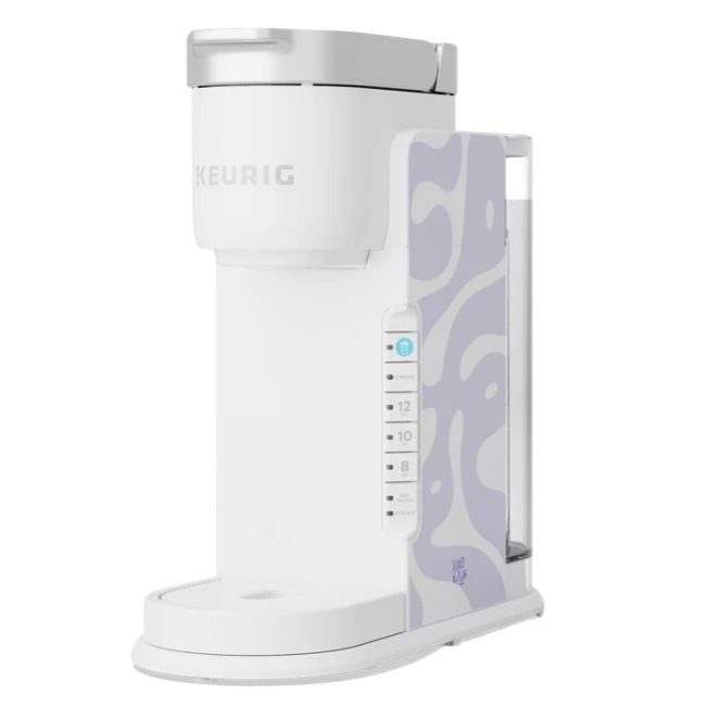 A white Keurig coffee maker featuring a light purple abstract pattern on the side, with controls for cup sizes and strength settings.