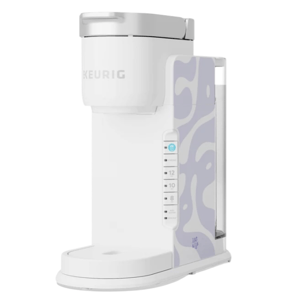 A white Keurig coffee maker featuring a light purple abstract pattern on the side, with controls for cup sizes and strength settings.