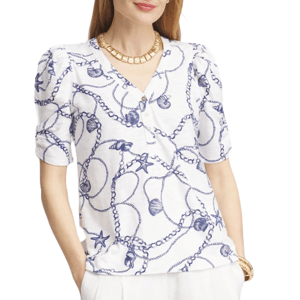 White Henley tee with blue nautical-themed design featuring seashells, starfish, and chains, short sleeves with slightly puffed shoulders, and a V-neck with buttons.