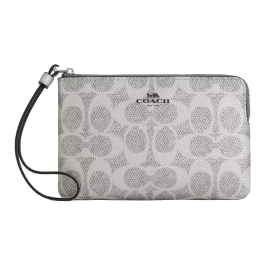 A Coach wristlet with a zip closure featuring the brand's signature 'C' pattern and a detachable strap.