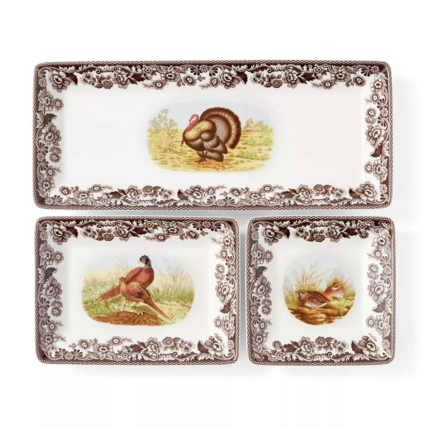 A set of three rectangular plates with floral borders and wildlife illustrations, featuring a turkey, pheasants, and a quail.