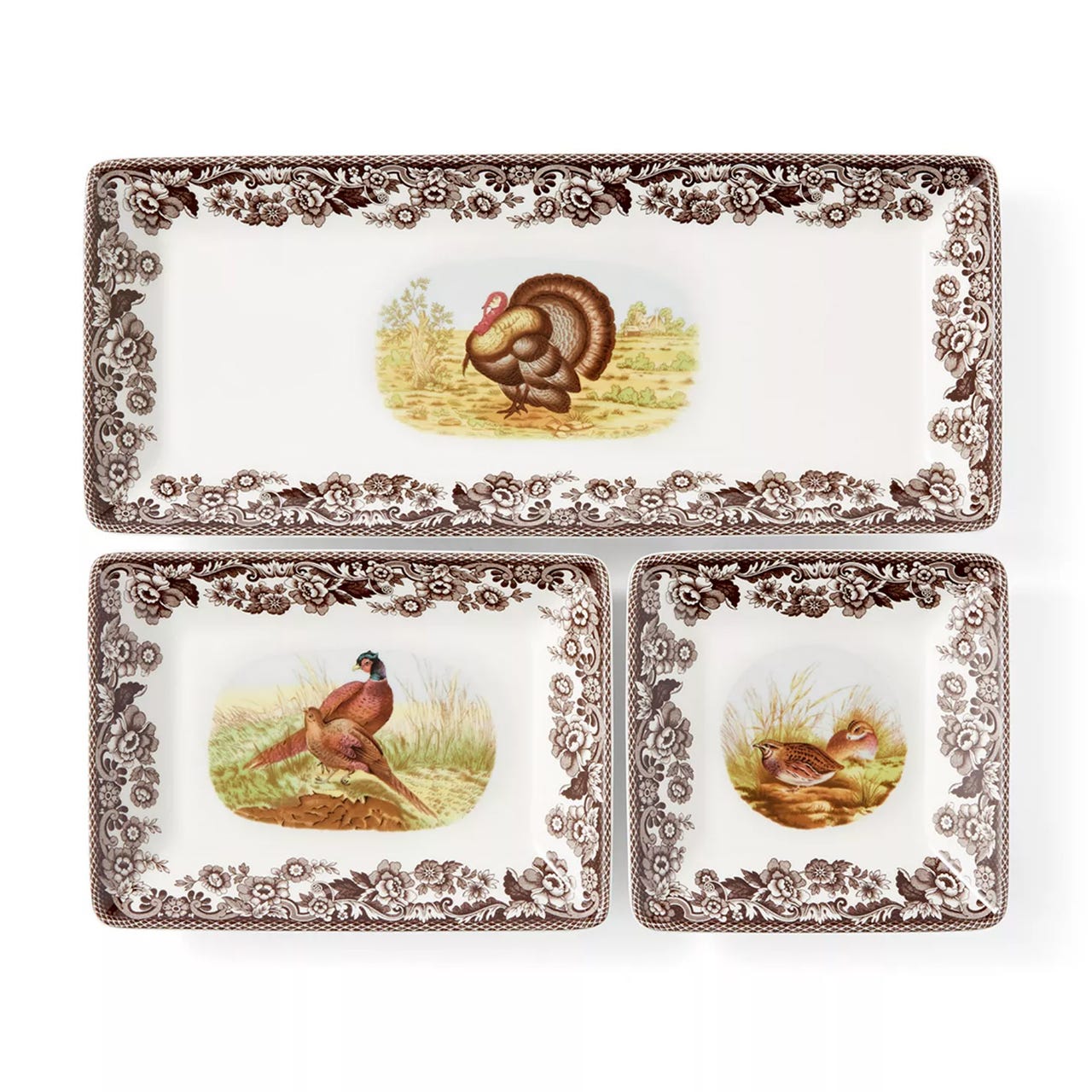 A set of three rectangular plates with floral borders and wildlife illustrations, featuring a turkey, pheasants, and a quail.
