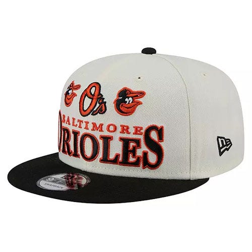A baseball cap featuring the Baltimore Orioles logo and text in red and black with a white crown and black brim.