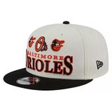 A baseball cap featuring the Baltimore Orioles logo and text in red and black with a white crown and black brim.