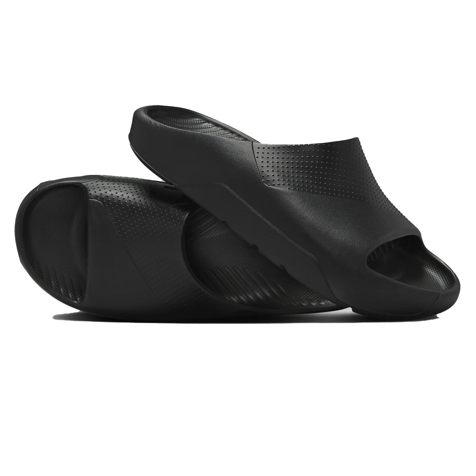 A pair of black slide sandals with a sleek design and small perforations for breathability. They have a contoured shape with open toes and a textured footbed for comfort.