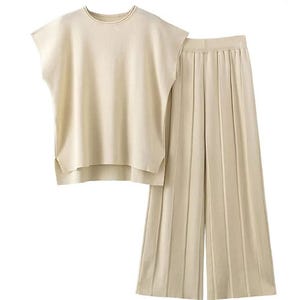 A cream-colored sleeveless top paired with matching wide-leg pleated trousers, featuring a clean and simple design.
