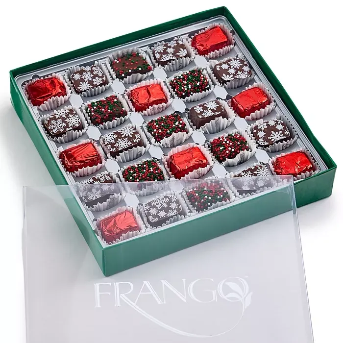 A 25-piece box of Frango Holiday Milk Mint Chocolates in a green box, featuring chocolates wrapped in red foil and topped with festive sprinkles and snowflake decorations.