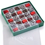 A 25-piece box of Frango Holiday Milk Mint Chocolates in a green box, featuring chocolates wrapped in red foil and topped with festive sprinkles and snowflake decorations.