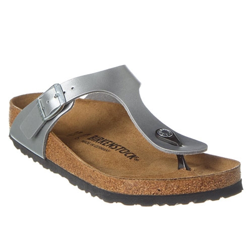 Birkenstock Gizeh Sandals in metallic silver feature a thong-style strap with an adjustable buckle, cork footbed, and rubber sole. They offer a casual yet supportive design suitable for comfortable walking.