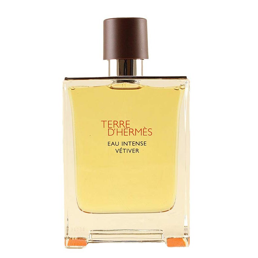 Hermès Terre D'Hermès Eau Intense Vetiver EDP is an amber-colored fragrance in a rectangular bottle with a dark brown cap, featuring vetiver as a key note.