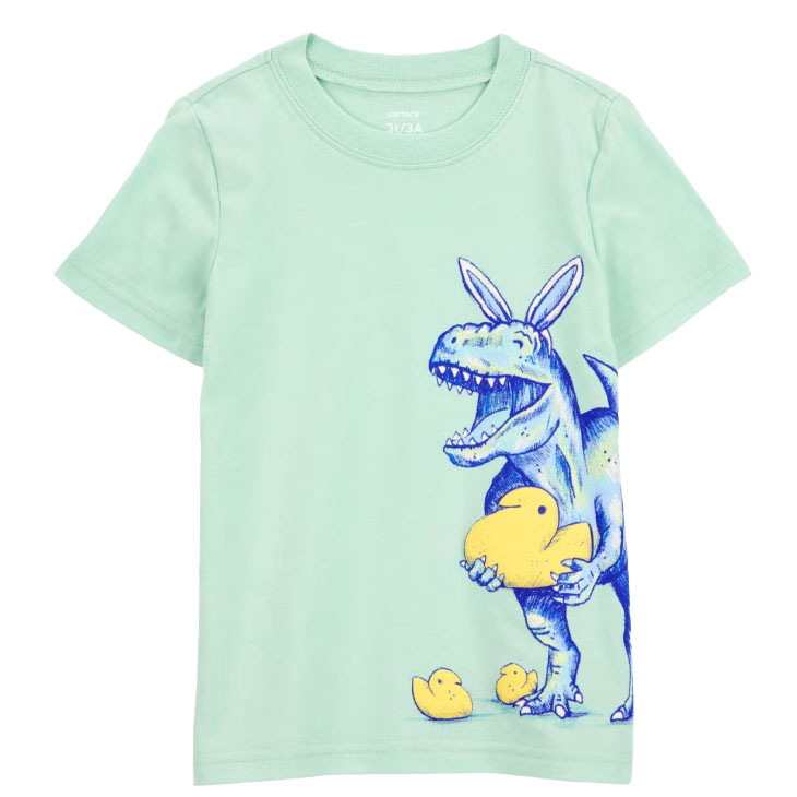A mint green tee featuring a blue dinosaur with bunny ears holding a large yellow rubber duck, with two smaller ducks at its feet.