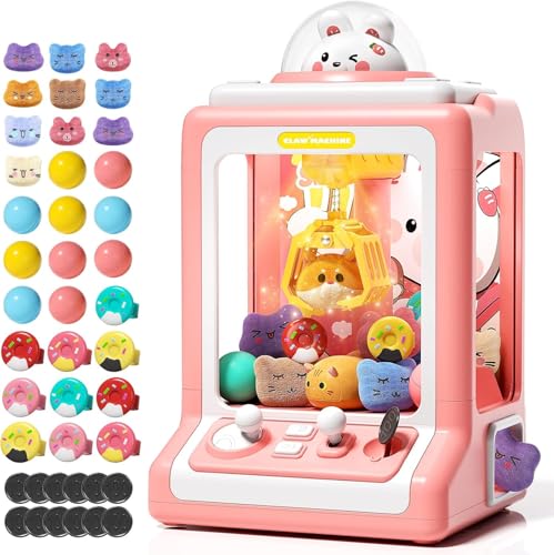 A pink toy claw machine containing small plush animals and accessories, shown with colorful balls, additional plush figures, and tokens for play.