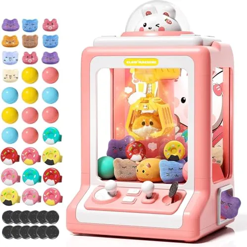 A pink toy claw machine containing small plush animals and accessories, shown with colorful balls, additional plush figures, and tokens for play.