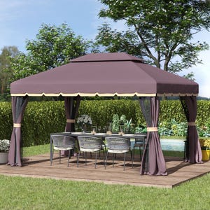 A gazebo with a purple canopy and curtains, set on a wooden deck, shelters an outdoor dining table and woven chairs. It's surrounded by lush greenery.