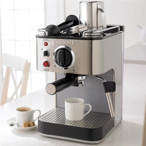A Cuisinart espresso machine with two cups, one filled with coffee.