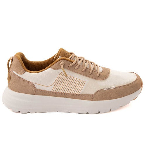 A beige and white sneaker with a light brown suede trim, featuring a white sole and lace-up closure.