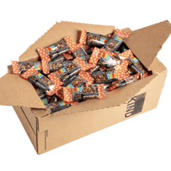 A cardboard box filled with multiple packs of KIND nut bars, featuring an orange and white starry design on the packaging.