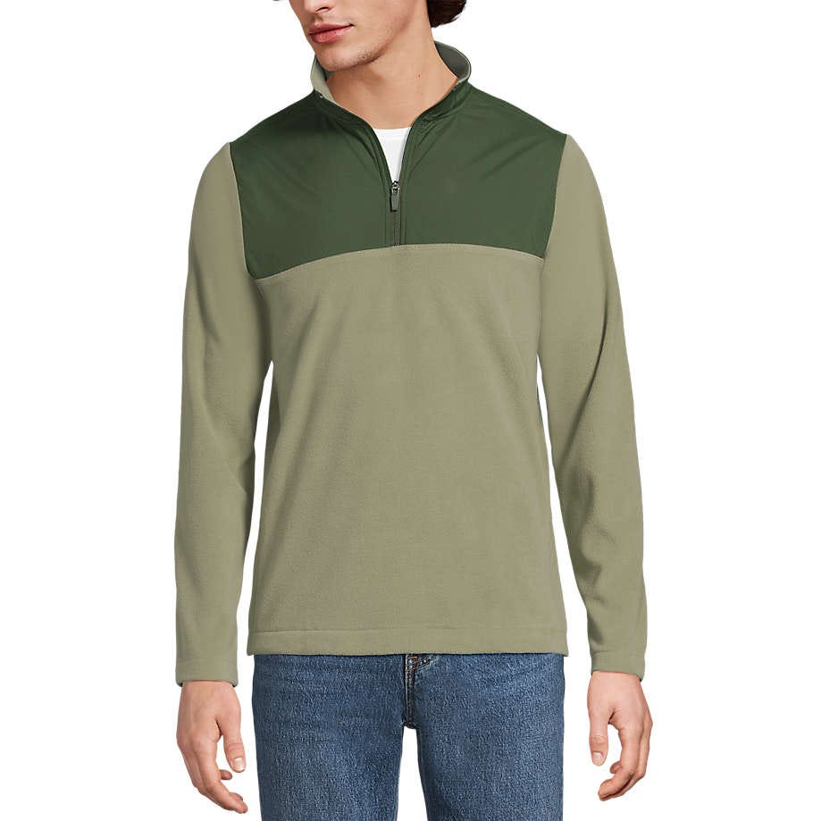 A two-tone, long-sleeve pullover with a zip-up collar in olive green and dark green, paired with blue jeans.