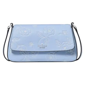 A light blue leather shoulder bag with a floral embossed pattern and a flap closure, featuring a thin strap and the Kate Spade New York logo on the front.