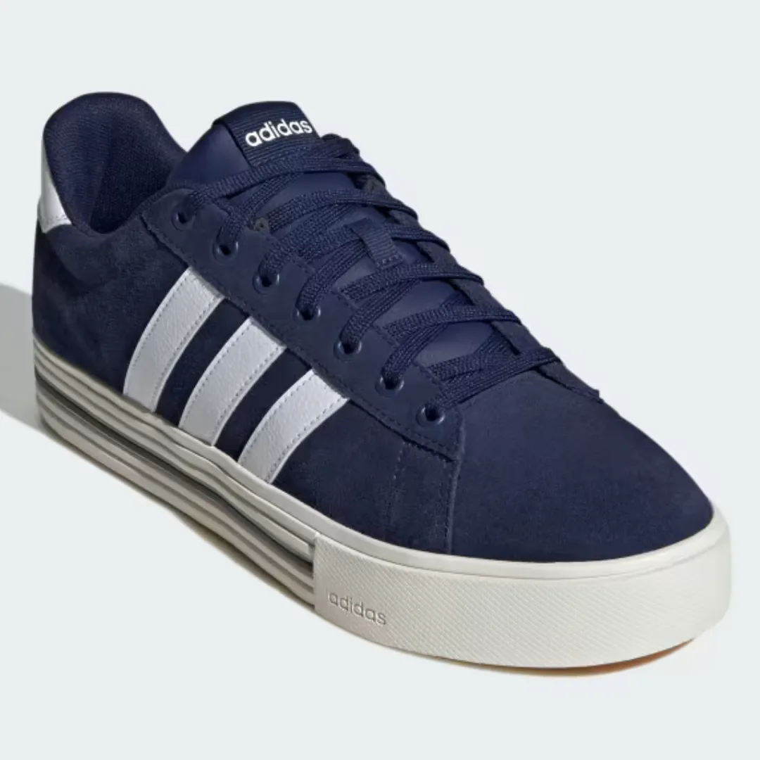 A pair of dark blue Adidas sneakers with white stripes and a beige sole.