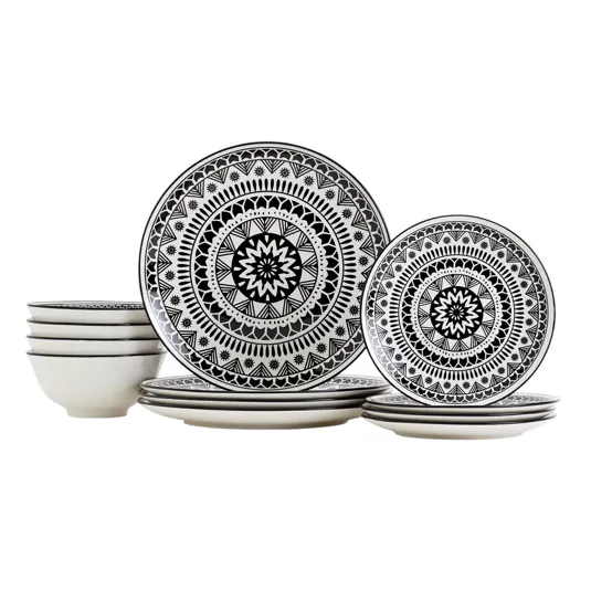 Set of black-and-white dinnerware featuring intricate geometric patterns, including large plates, small plates, and bowls.