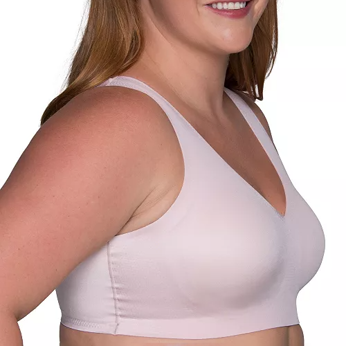 A woman is wearing a light pink, seamless bra with wide straps and a V-shaped neckline.