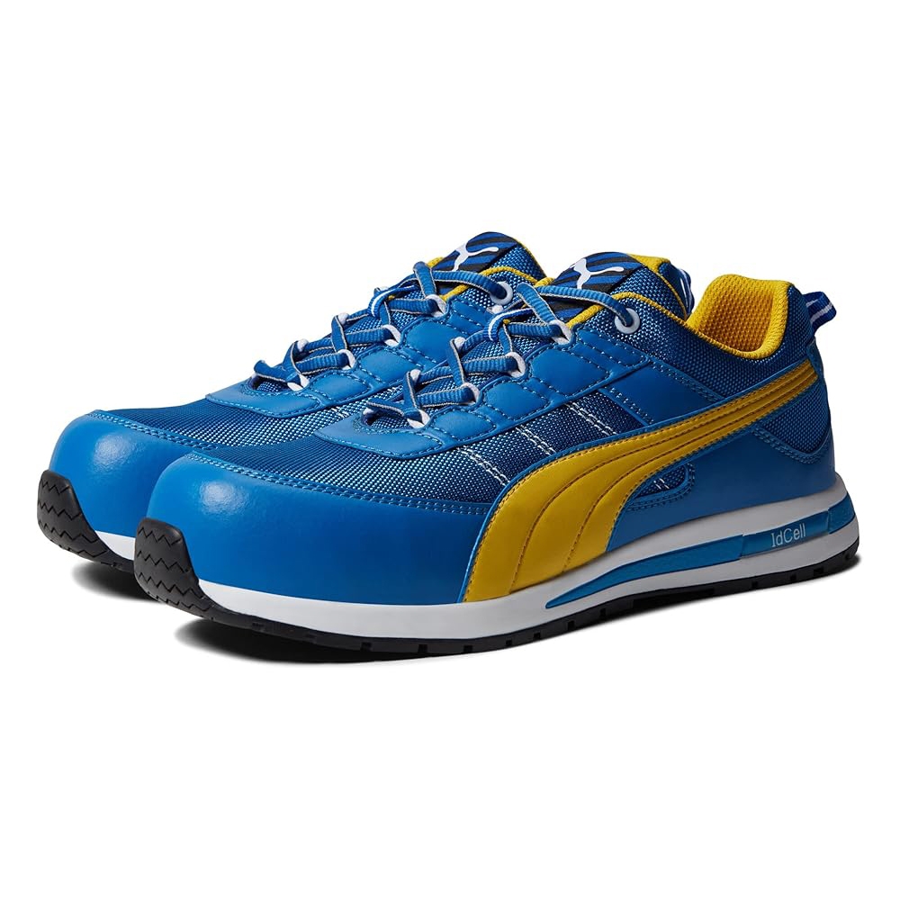 Puma Safety Kickflip Sneakers are blue with a contrasting yellow stripe, featuring a durable design, breathable mesh, and reinforced toecaps. They have a cushioned midsole with IdCell technology for comfort.