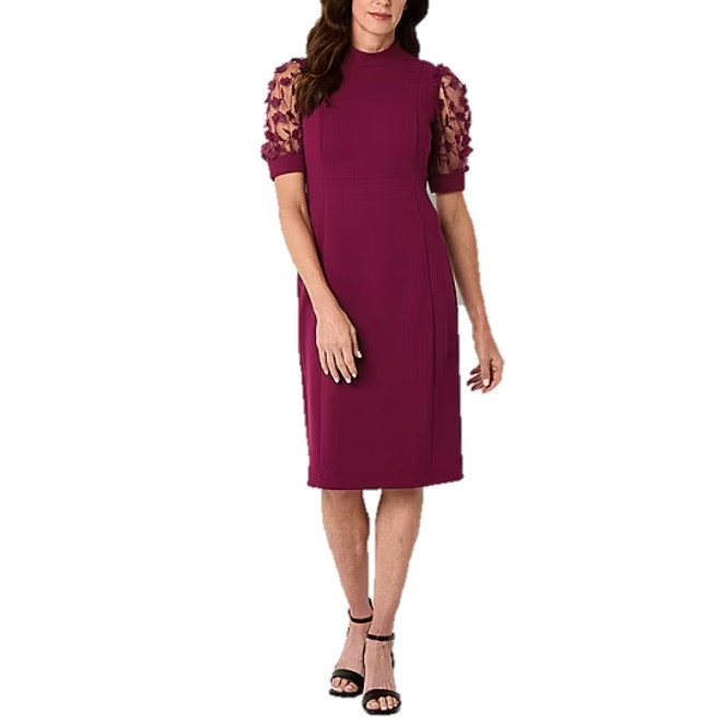 A knee-length, burgundy dress with short, sheer floral embroidered sleeves and a high neckline, paired with black strappy sandals.