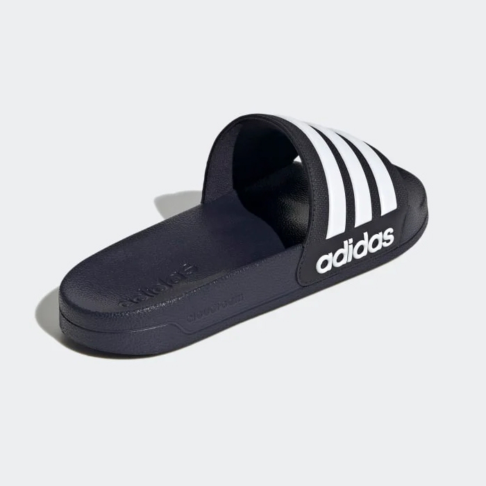 A single Adidas slide-on sandal with a black strap displaying white stripes and logo.