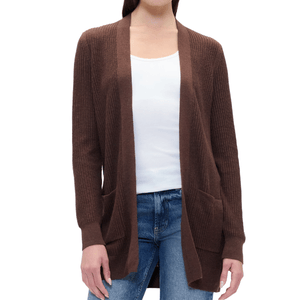 A woman is wearing a brown ribbed knit cardigan over a white tank top and jeans. The cardigan features an open front design with pockets.