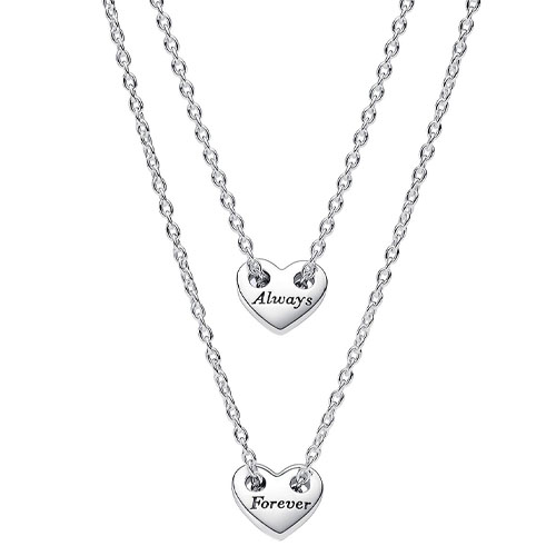 Two silver necklaces with heart-shaped pendants, one inscribed with \“Always\“ and the other with \“Forever\“. Each pendant is suspended from a delicate chain.