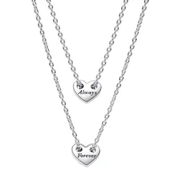 Two silver necklaces with heart-shaped pendants, one inscribed with \“Always\“ and the other with \“Forever\“. Each pendant is suspended from a delicate chain.