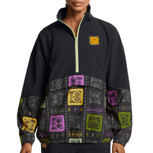 The UA Day of the Dead Anorak features a black quarter-zip design with colorful bandana prints in purple, yellow, and lime green. It has a relaxed fit and contrasting accents for a vibrant look.