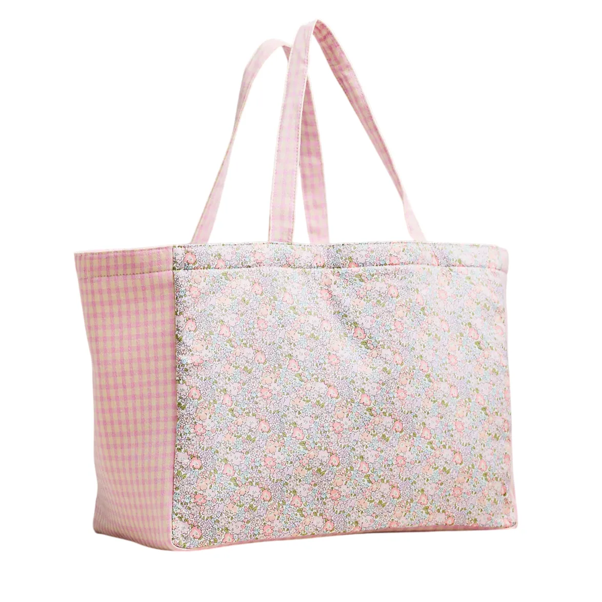 A pink tote bag with floral and checkered patterns, featuring two handles for carrying.