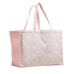A pink tote bag with floral and checkered patterns, featuring two handles for carrying.