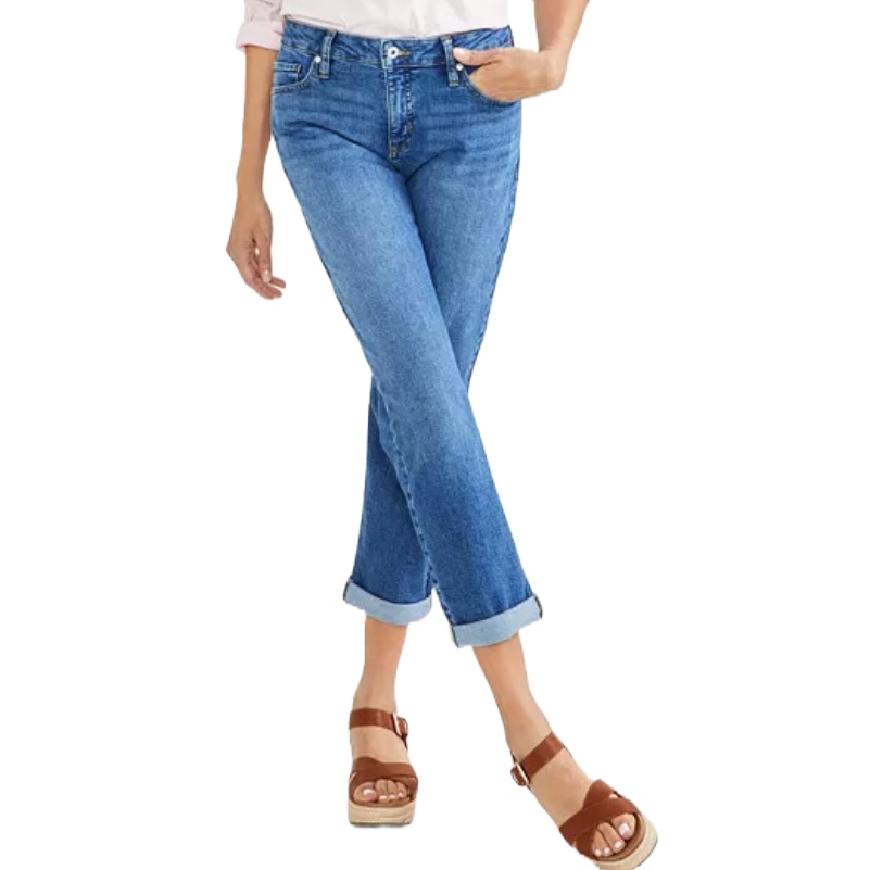 A person is wearing blue cuffed jeans paired with brown platform sandals.
