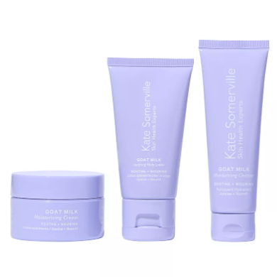 A set of three skincare products from Kate Somerville, including two tubes and one jar, labeled as Goat Milk Moisturizing Cream, designed to soothe and nourish skin, packaged in lavender-colored containers.