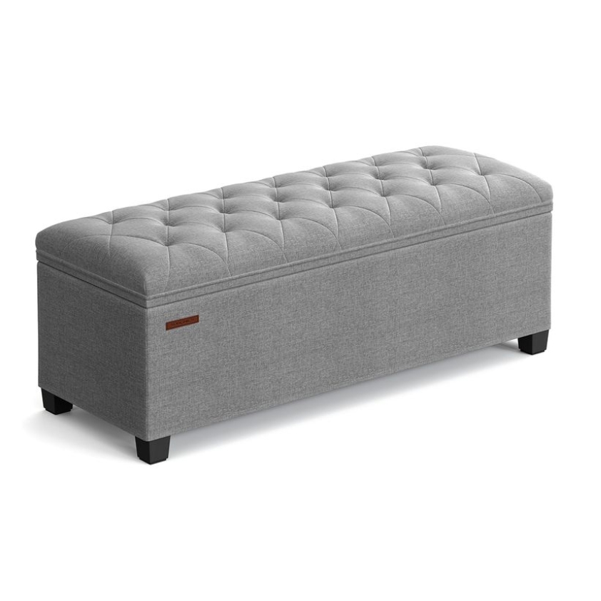 A gray, tufted, rectangular storage ottoman with dark wooden legs, measuring 43 inches in length.